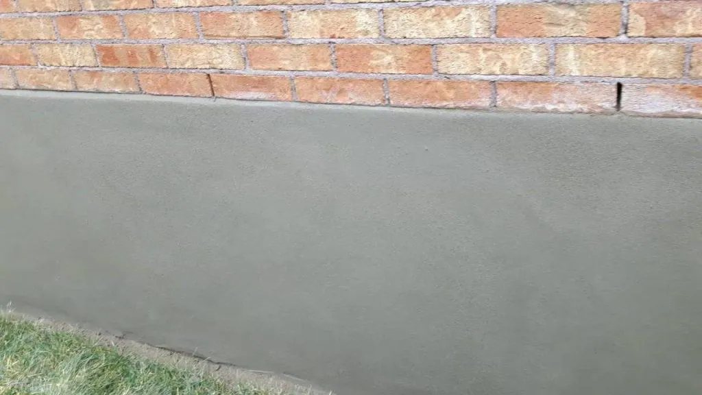 Smooth parge coat troweled over a finished concrete block wall