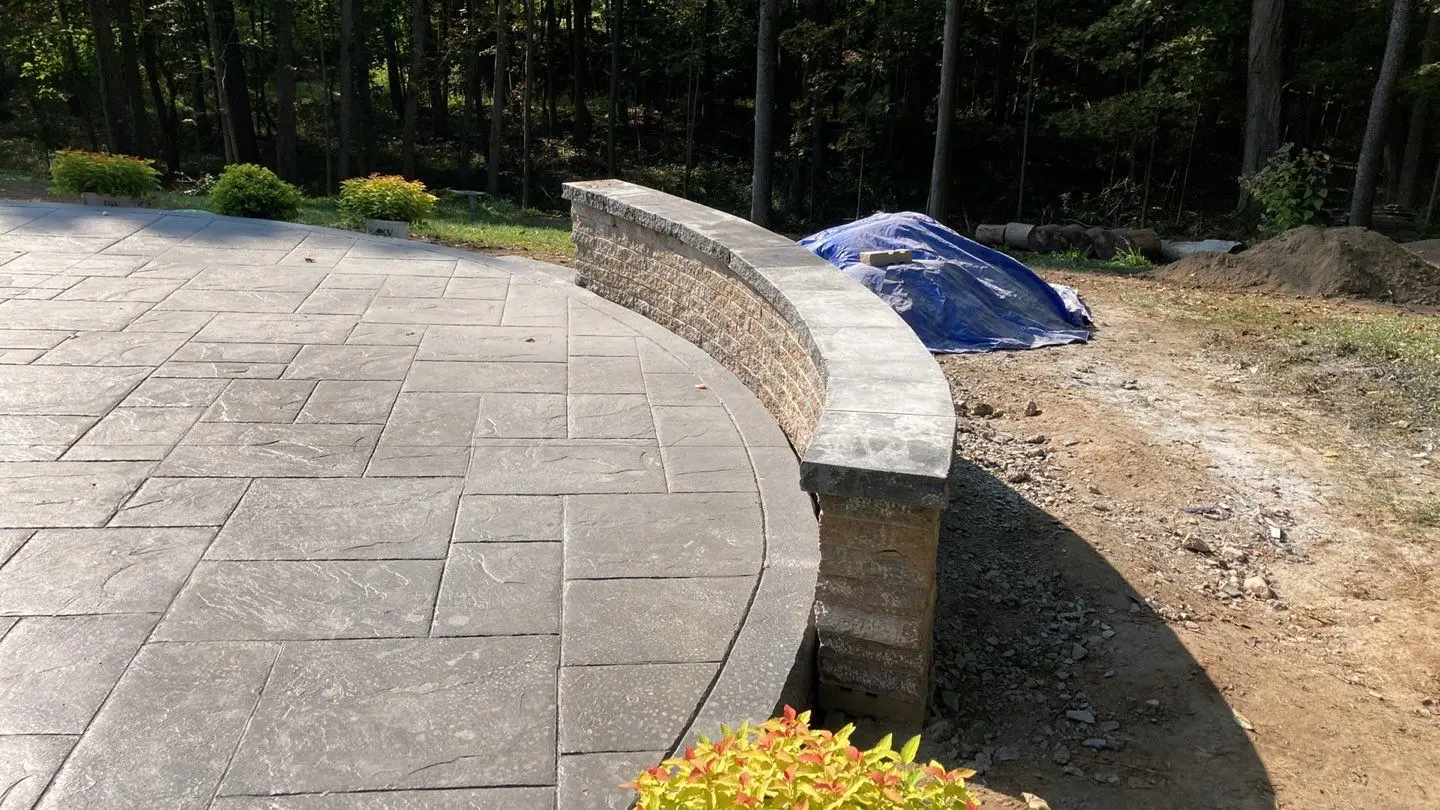 Close view of the Majestic Ashlar stamp pattern beside the capped mini crete block wall in Pittsford NY